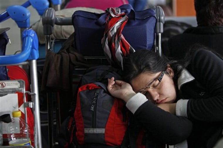 A girl sleeps at Jorge Newbery airport where flights were canceled due to an ash cloud that reached Buenos Aires from the Chilean Puyehue-Cordon Caulle volcano grounding air travel in Buenos Aires, Argentina.